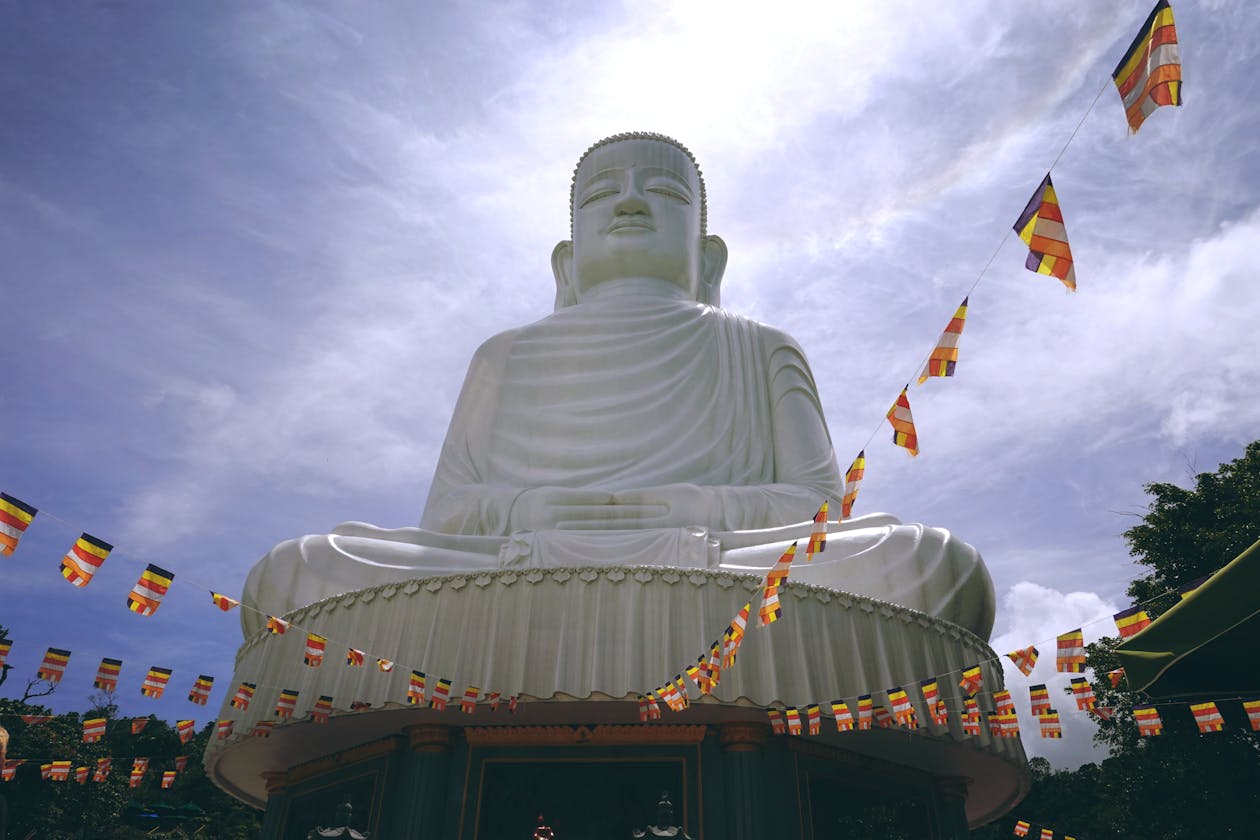 Large white Lady Buddha statue at Linh Ung Pagoda in Da Nang against a blue sky