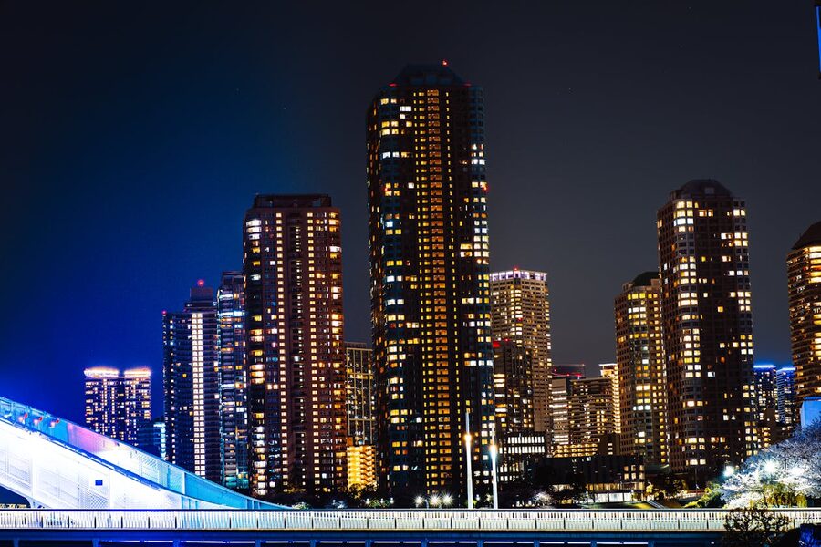 Night view of Tokyo illuminated skyscrapers against dark sky