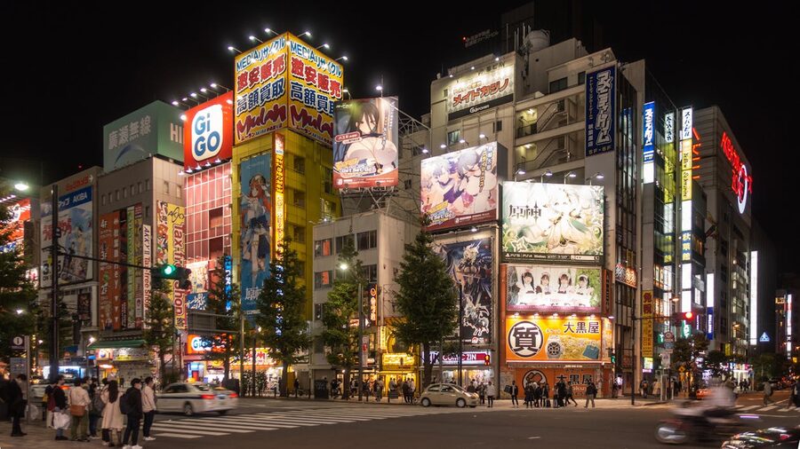 Colorful illuminated street in Akihabara Tokyo at night with anime billboards