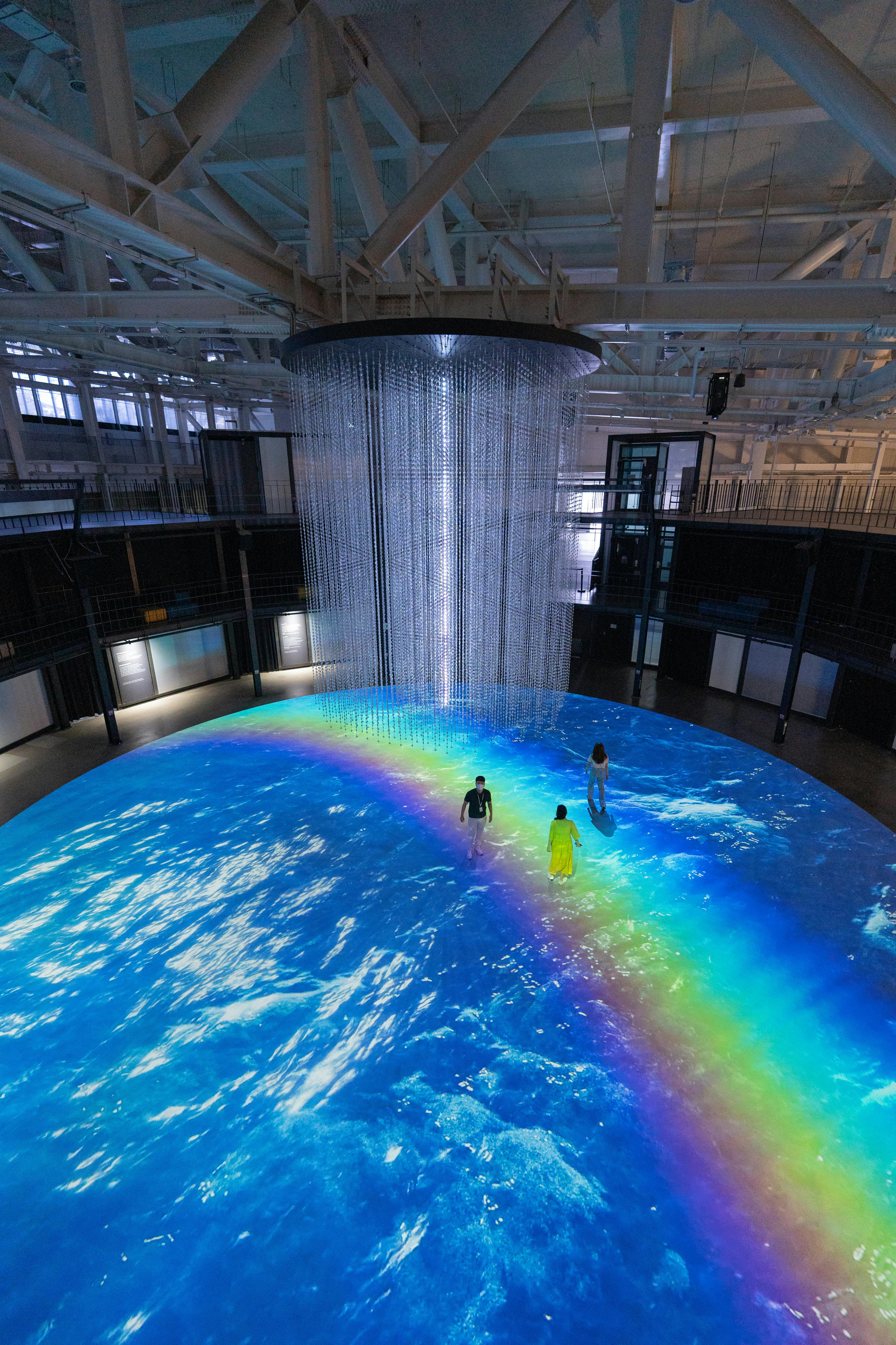 Indoor art installation with waterfall effect and rainbow lighting