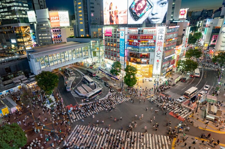 Shibuya Scramble Crossing illuminated at night with crowds of pedestrians