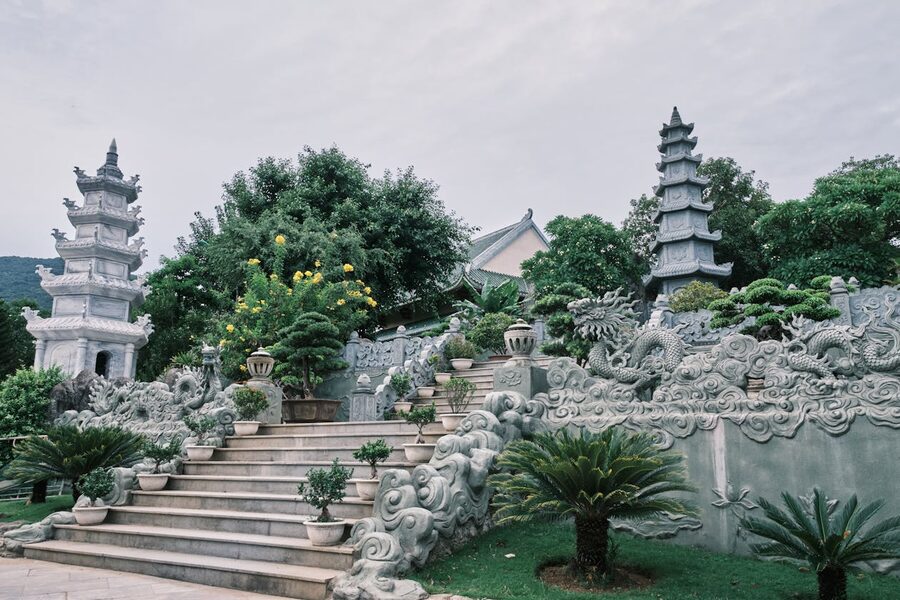 Buddhist temple garden with pagodas surrounded by greenery in Da Nang