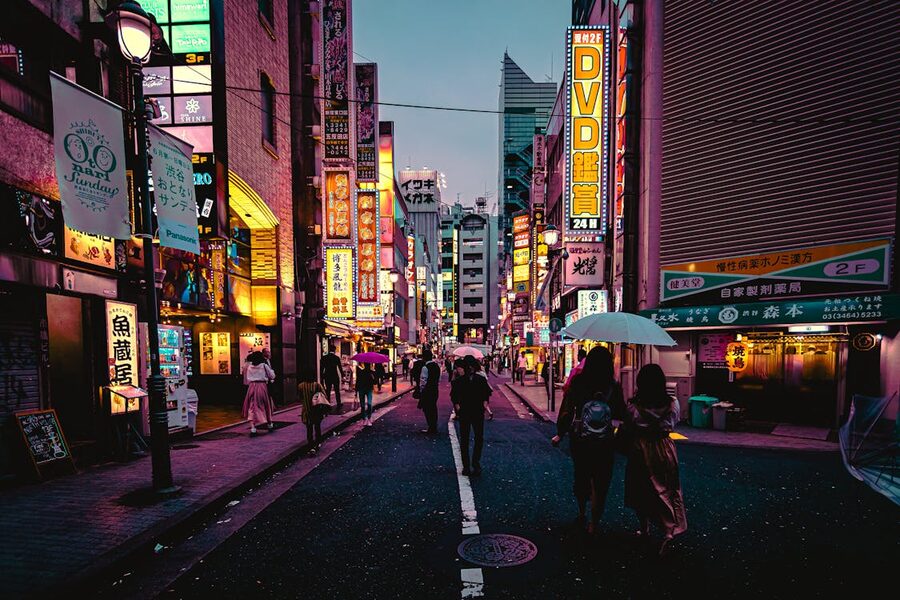 Street scene in downtown Tokyo Japan with neon lights and pedestrians