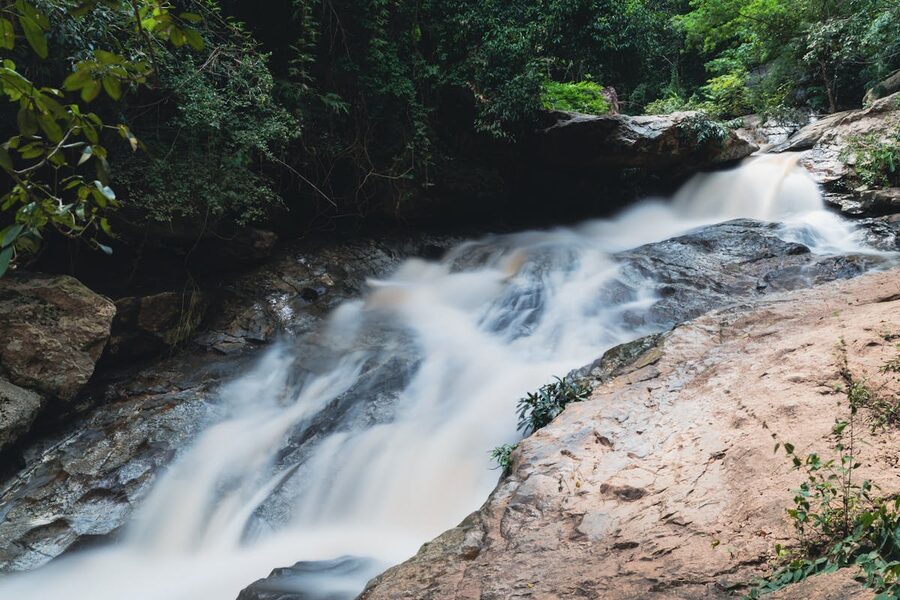 A waterfall cascading over rocks in Chiang Mai forest