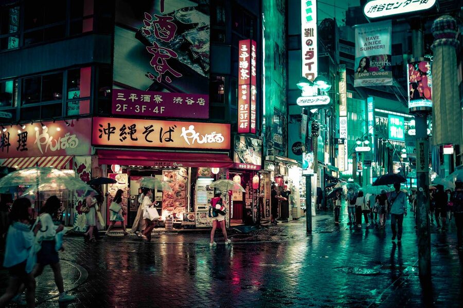 Neon-lit streets of Shibuya Tokyo at night with signs and lights