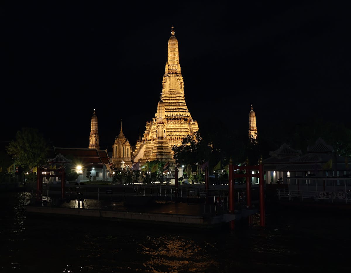 Wat Arun Temple illuminated at night in Bangkok Thailand