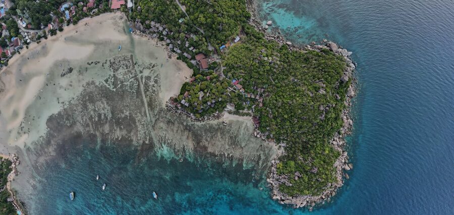 Aerial view of Ko Tao peninsula with lush hills and turquoise waters