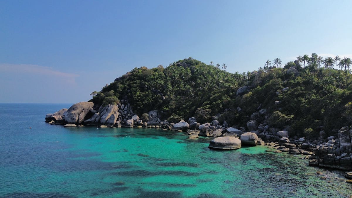 Lush coastline and clear turquoise waters of Ko Tao Thailand