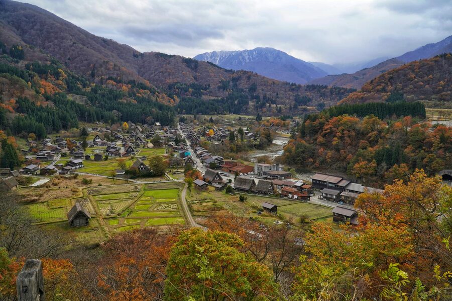 Aerial view of Shirakawa-go village with traditional gassho-zukuri houses surrounded by autumn foliage