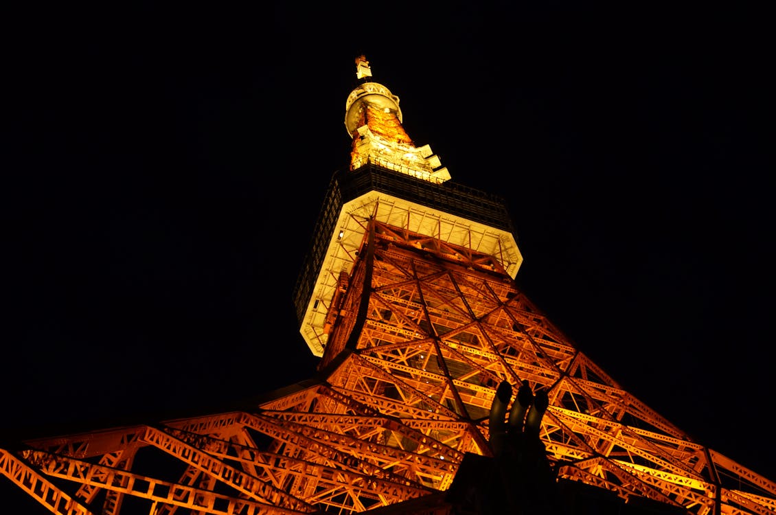 Tokyo Tower glowing brightly against the night sky in Tokyo Japan