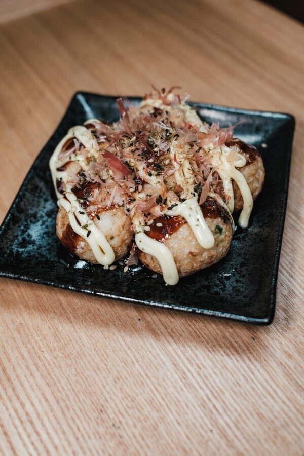 Close-up of takoyaki topped with mayonnaise and bonito flakes