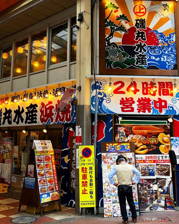 lively street food market in Osaka with iconic signage and crowded stalls