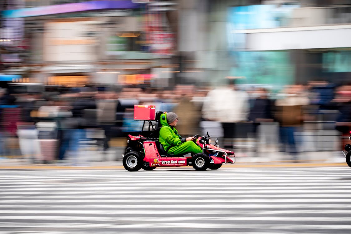 Colorful go-karts driving through the famous Shibuya Crossing in Tokyo Japan