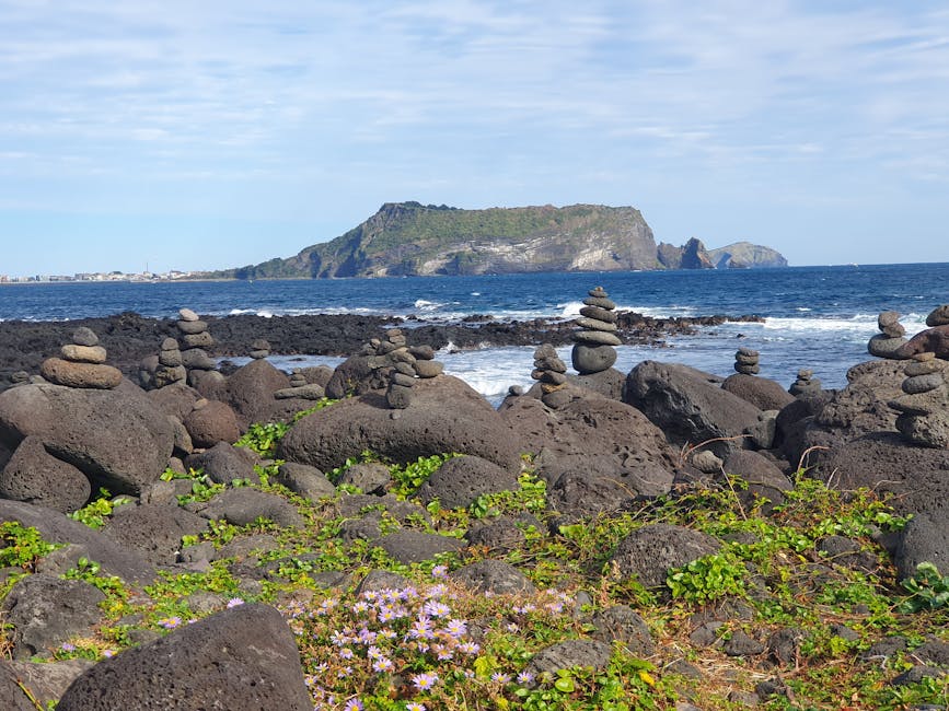 Zen rock stacks on Jeju Island coast at sunset
