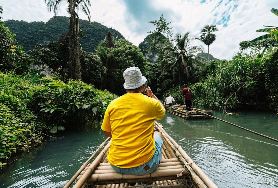 Bamboo rafting adventure through a lush jungle in Thailand