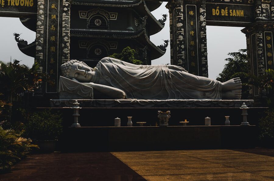 Reclining Buddha statue with ornate temple backdrop in Da Nang