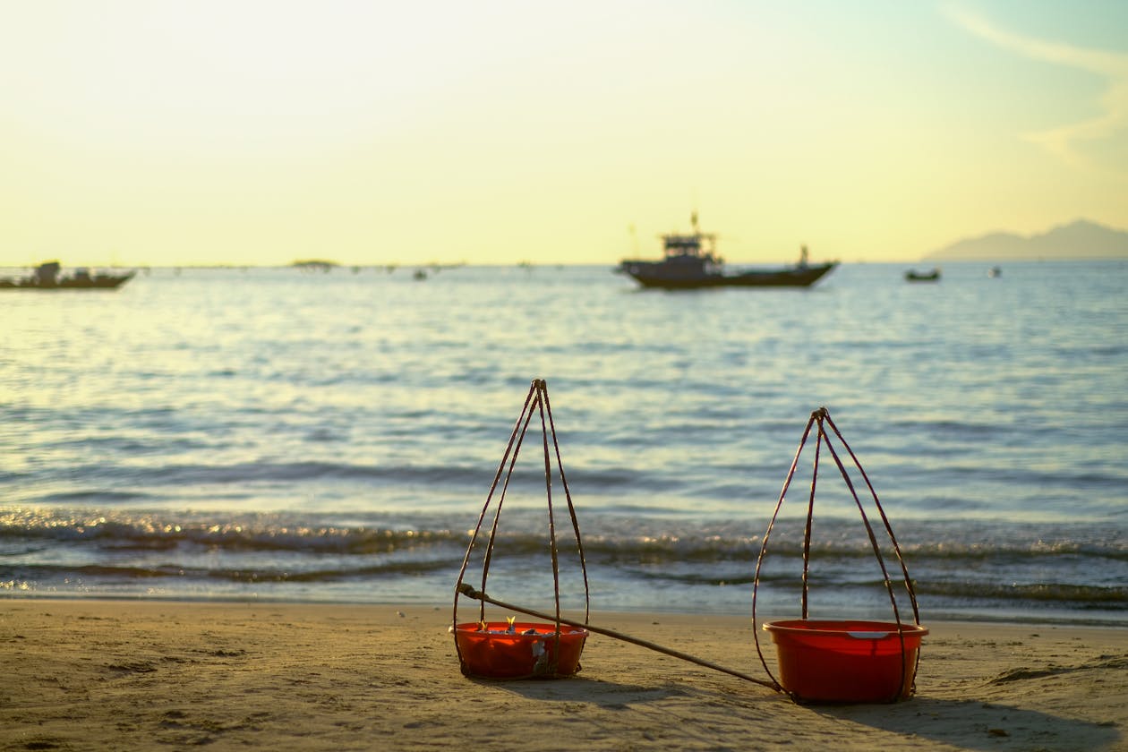 Dawn at Da Nang beach with traditional baskets and boats