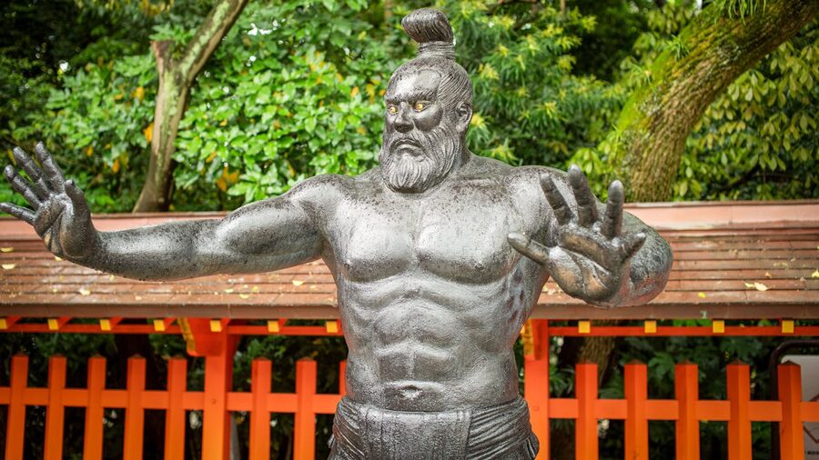 A statue of a sumo god in a Japanese temple courtyard in Fukuoka Japan