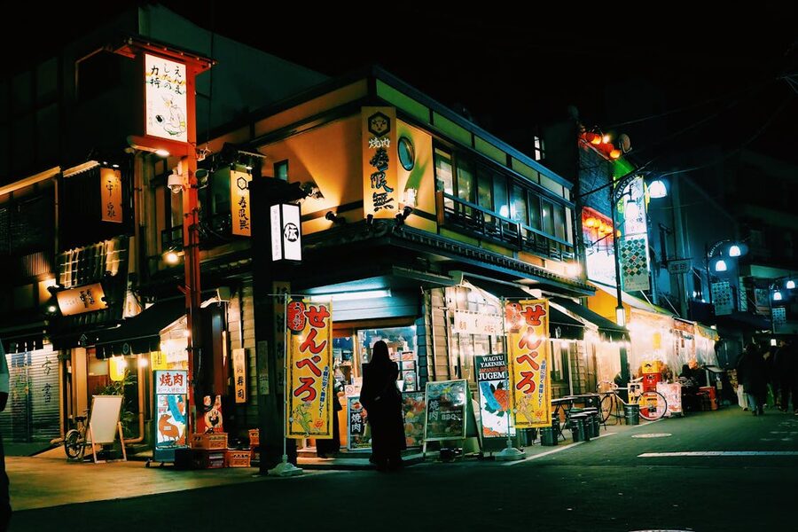 Traditional shops in Tokyo at night with glowing neon signs