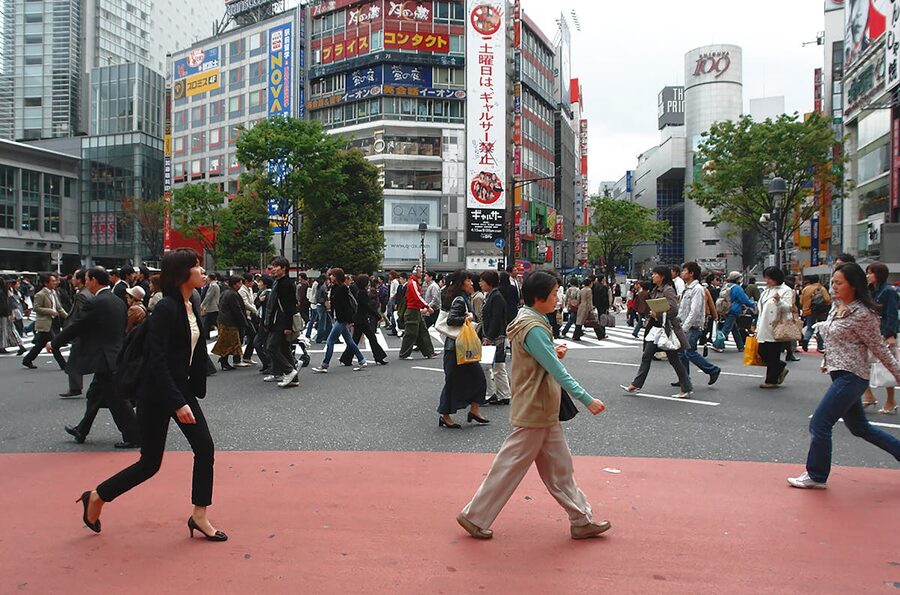 People crossing at the iconic Shibuya Crossing in Tokyo during the day