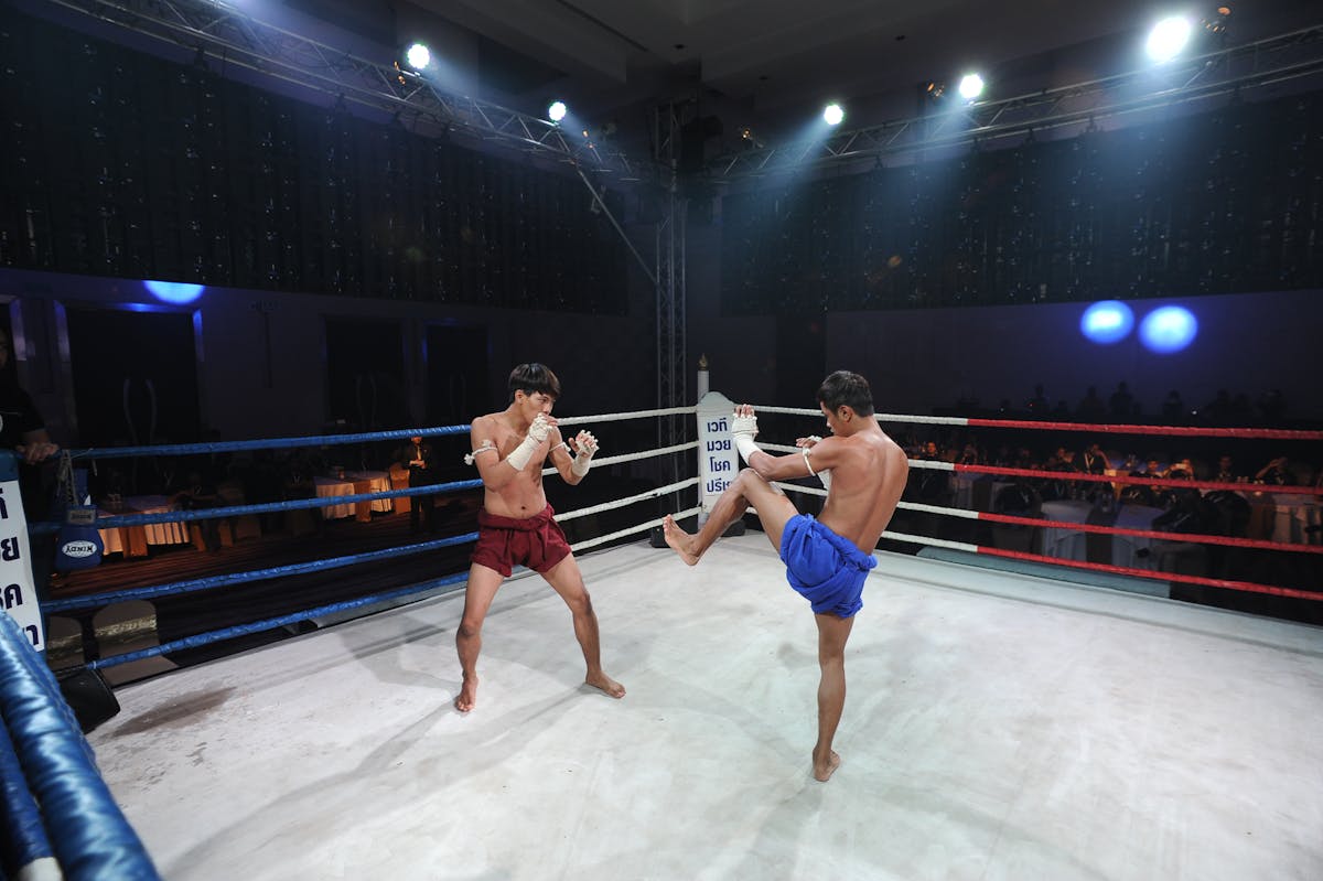Two Muay Thai fighters in an intense match in Thailand