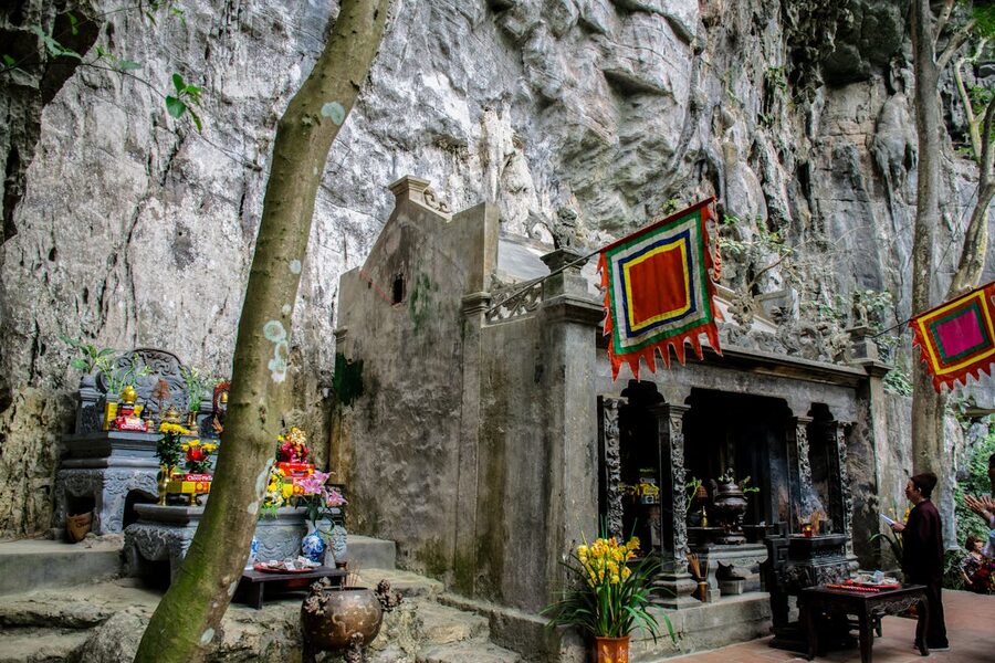 Buddhist shrine inside a cave temple in Vietnam with natural light filtering through