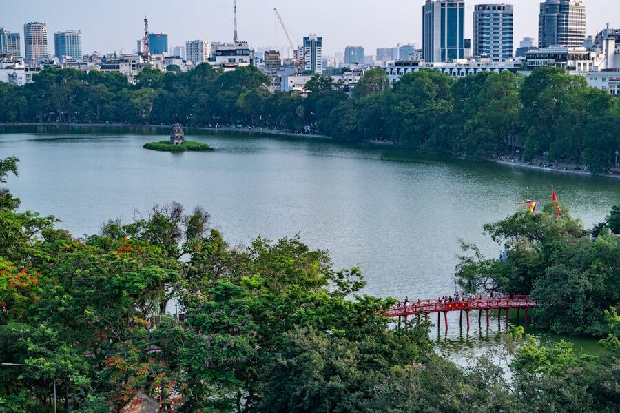 Aerial view of Hoan Kiem Lake with the Turtle Tower and surrounding Hanoi cityscape