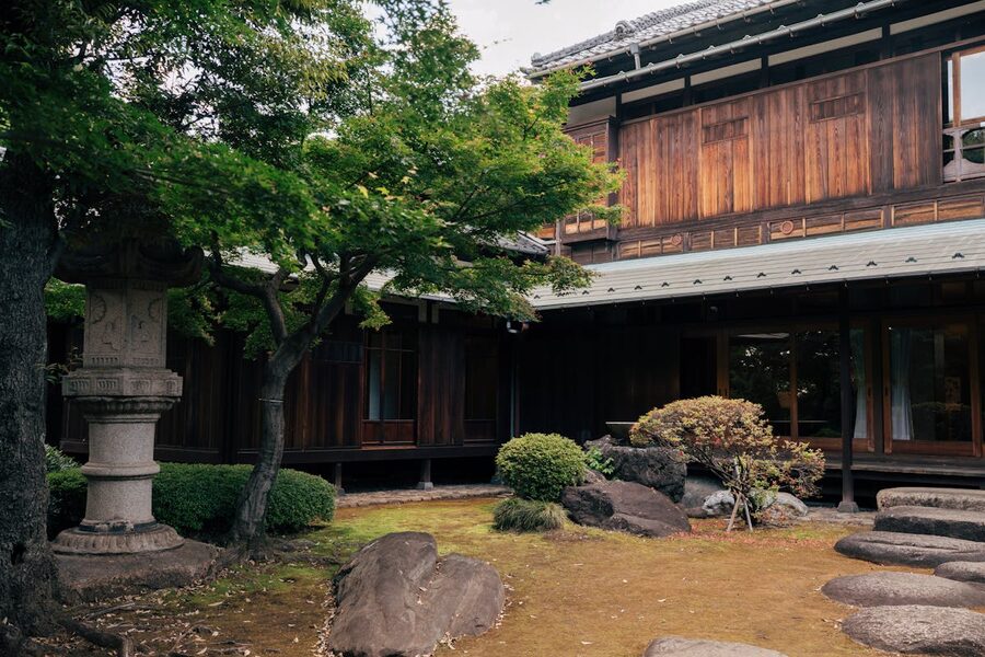 Authentic Japanese wooden house surrounded by a carefully maintained green garden in Tokyo