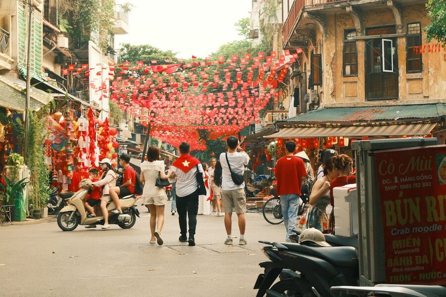 People enjoying a colorful festival in Hanoi Old Quarter with decorations