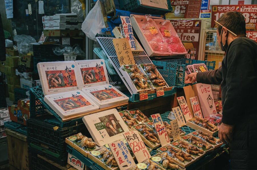 Japanese seafood vendor arranging fresh seafood at a market stall