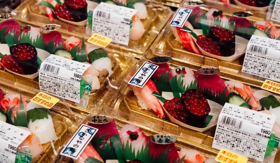 Assorted fresh sushi arranged in traditional Japanese packaging