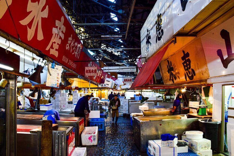 Vendors and shoppers at Tsukiji outer market in Tokyo at night