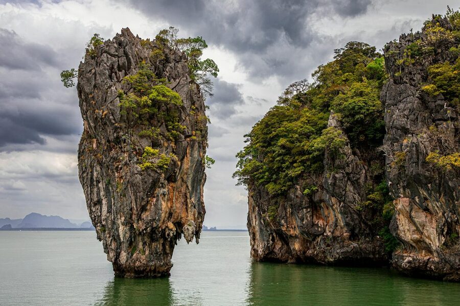 Massive limestone cliffs rising from the sea near Ko Panyi Phang Nga