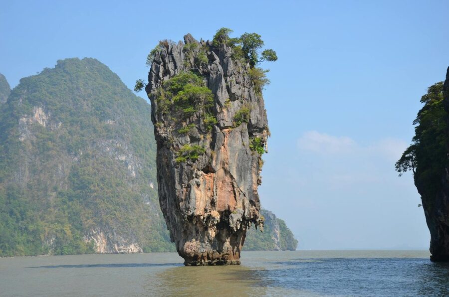 A single limestone island formation rising from turquoise waters in Phang Nga Bay