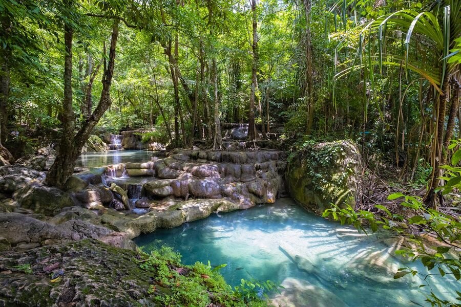 Serene waterfall cascading into pools in a Thai rainforest