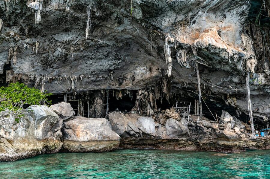 Dramatic sea cave formations along the rocky coastline of Phuket Thailand