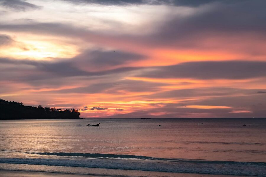 Colorful sunset over the calm Andaman Sea viewed from Phuket Thailand