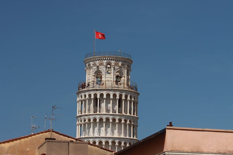 Leaning Tower of Pisa rising above terracotta rooftops