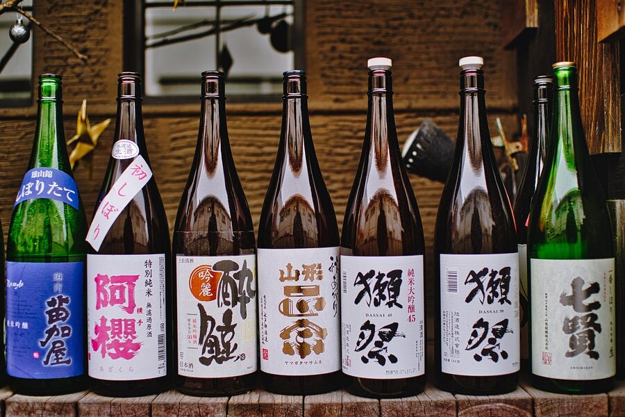 Rows of sake bottles displayed at a Japanese bar