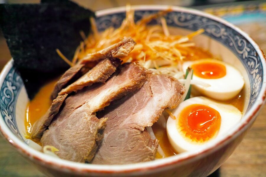 Bowl of Japanese ramen with sliced pork, nori, and green onions