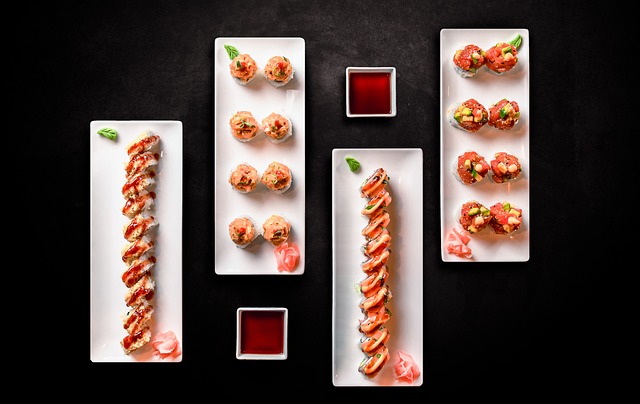 Flat lay arrangement of various Japanese sushi rolls with fresh ingredients