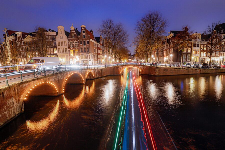 Amsterdam canal at night with Christmas light tracks
