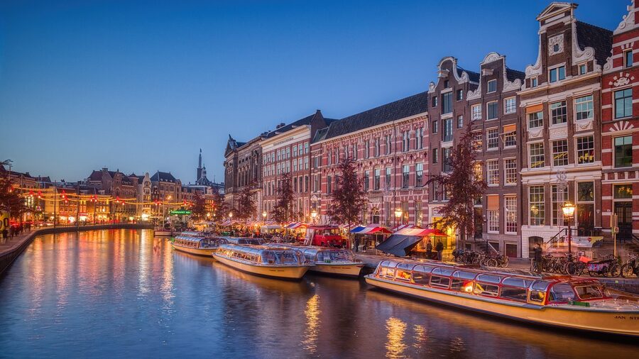 Amsterdam canal evening reflection with boats