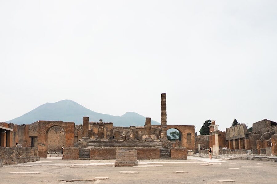 Pompeii ruins with Mount Vesuvius rising in the background under a clear sky