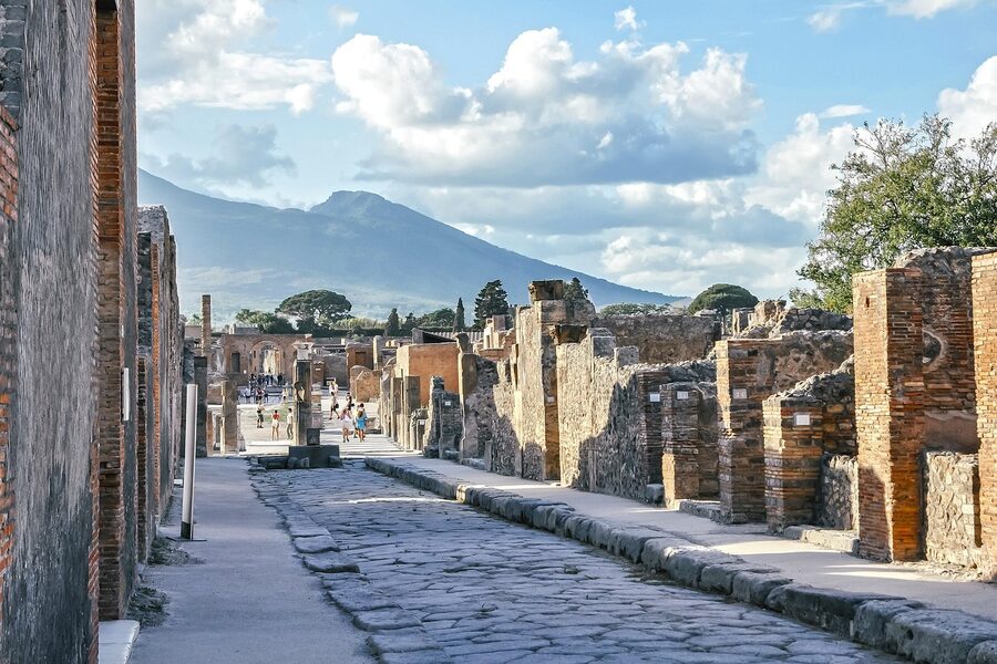 Pompeii ancient street with Mount Vesuvius visible in the distance