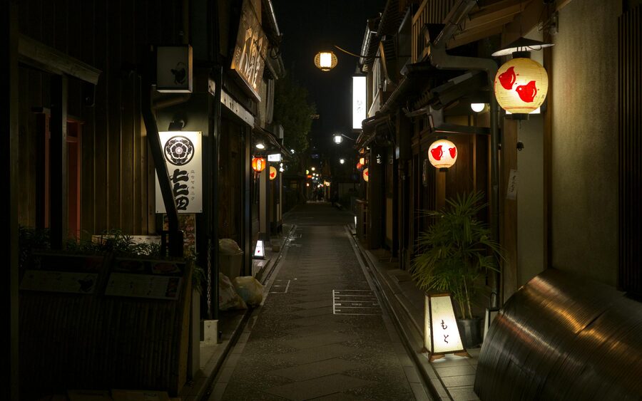 Traditional buildings along Pontocho alley in Kyoto lit by warm lantern light at night