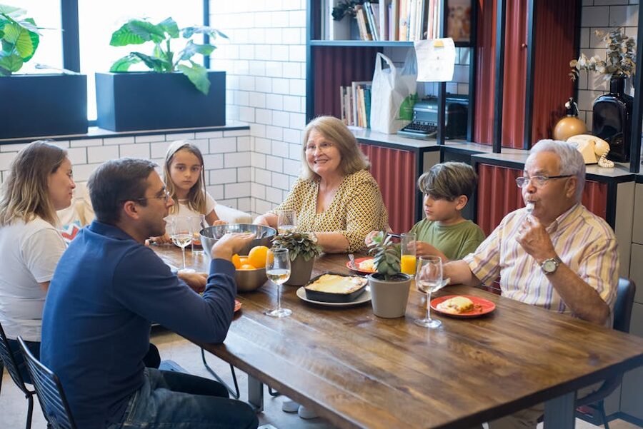 Family-style group lunch at a long wooden table