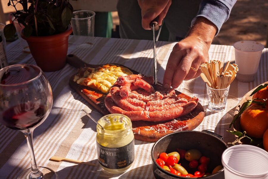 Outdoor lunch table with food being served in a vineyard setting