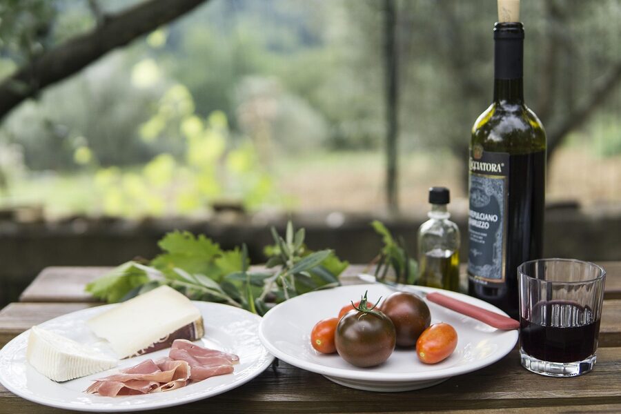 Outdoor table set with wine and Portuguese cheese