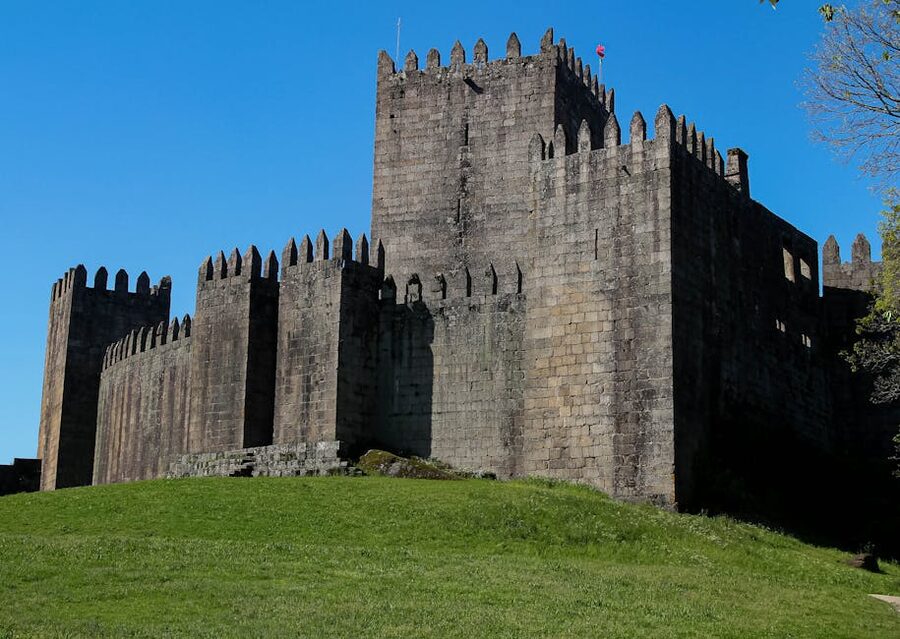 Medieval walls of Guimaraes Castle from below